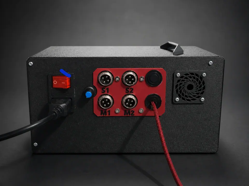 Custom black sim-racing control enclosure with organized connectors, switch, cable, and cooling fan